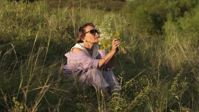 一位上了年纪但依然迷人的亚洲女性，在阳光明媚的公园里呼吸着野花的清香。这个形象传达了快乐和放松。大自