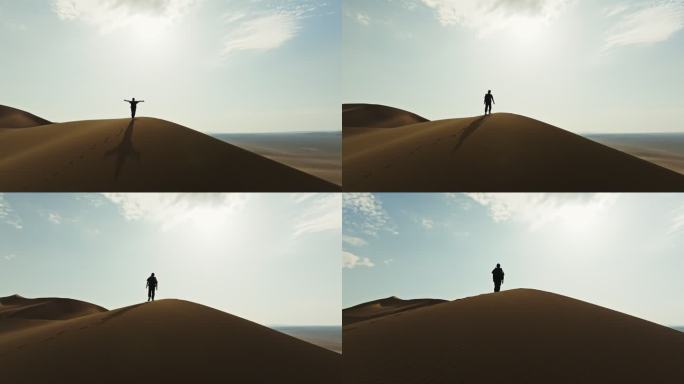 爬沙漠库木塔格沙漠上徒步的人克服困难励志
