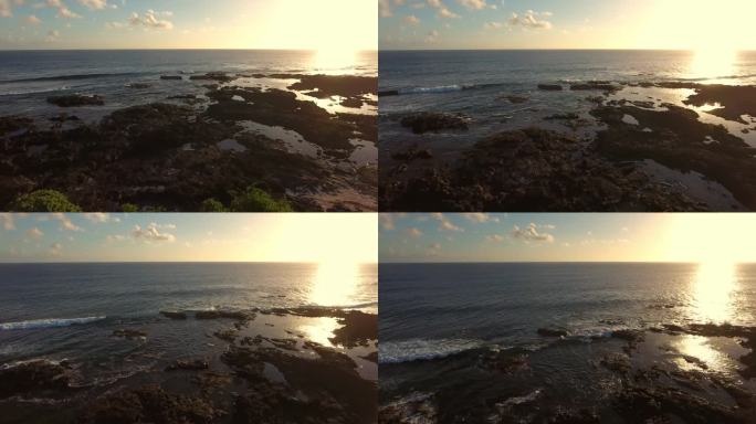 航拍夕阳下的海边礁石海浪天际线