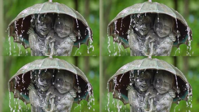 喷泉与雕塑家弗里多·格拉齐亚尼(Frido Graziani)创作的伞下两个孩子的雕塑(特写)