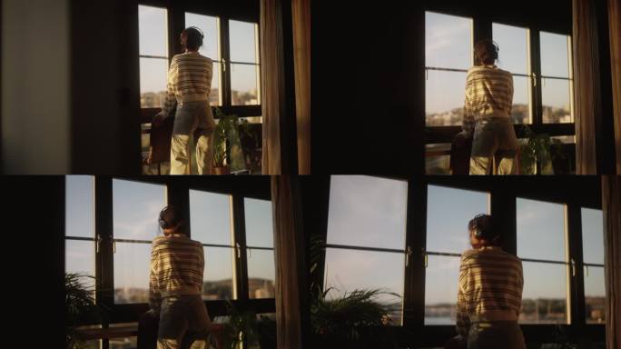 一个女人从她的公寓向外看日落