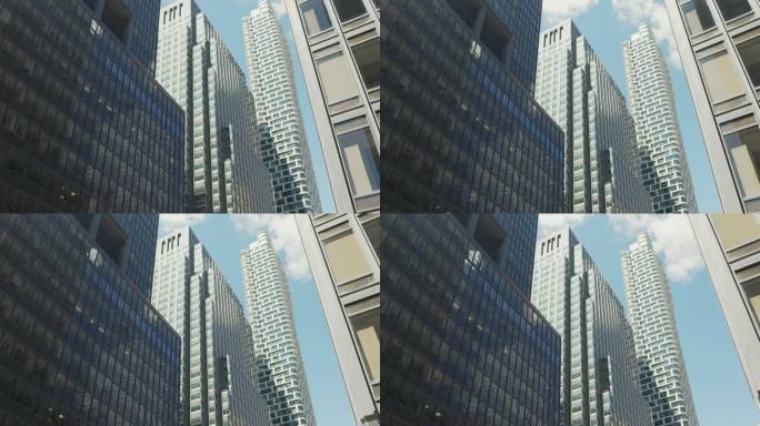 纽约一组现代办公大楼的低角度视图。曼哈顿摩天大楼在蓝天背景与轻云。旅游理念，旅游，热门商务目的地