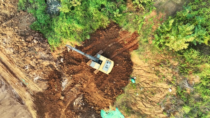 航拍拆迁工地上不停工作的挖掘机