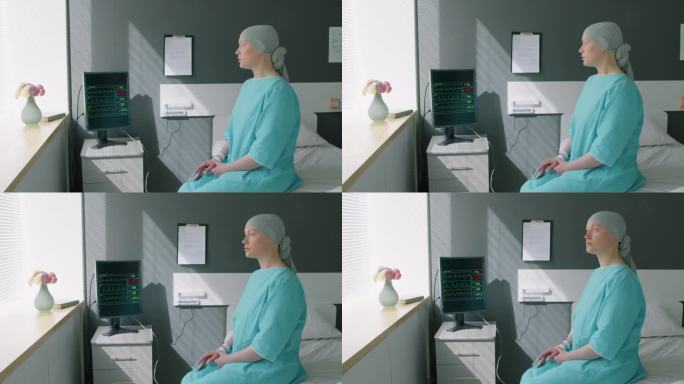 肿瘤科的病人坐在床上望着窗户