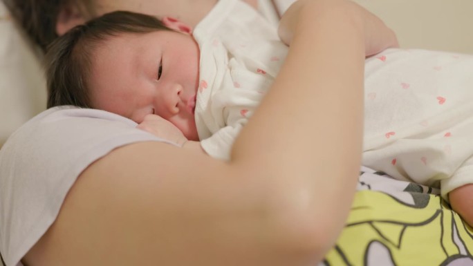 婴儿静静地躺在一位单身母亲身边