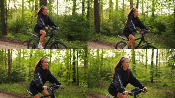 迷人的年轻女子独自骑自行车在美丽的森林在夏天，肖像在运动