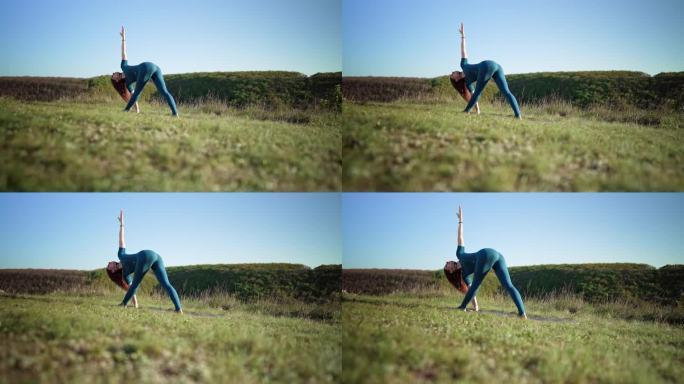 一位女瑜伽士在高山之巅做瑜伽练习——在深呼吸的情况下做三角体式。野性的自然，自由的人类。自由，健康的