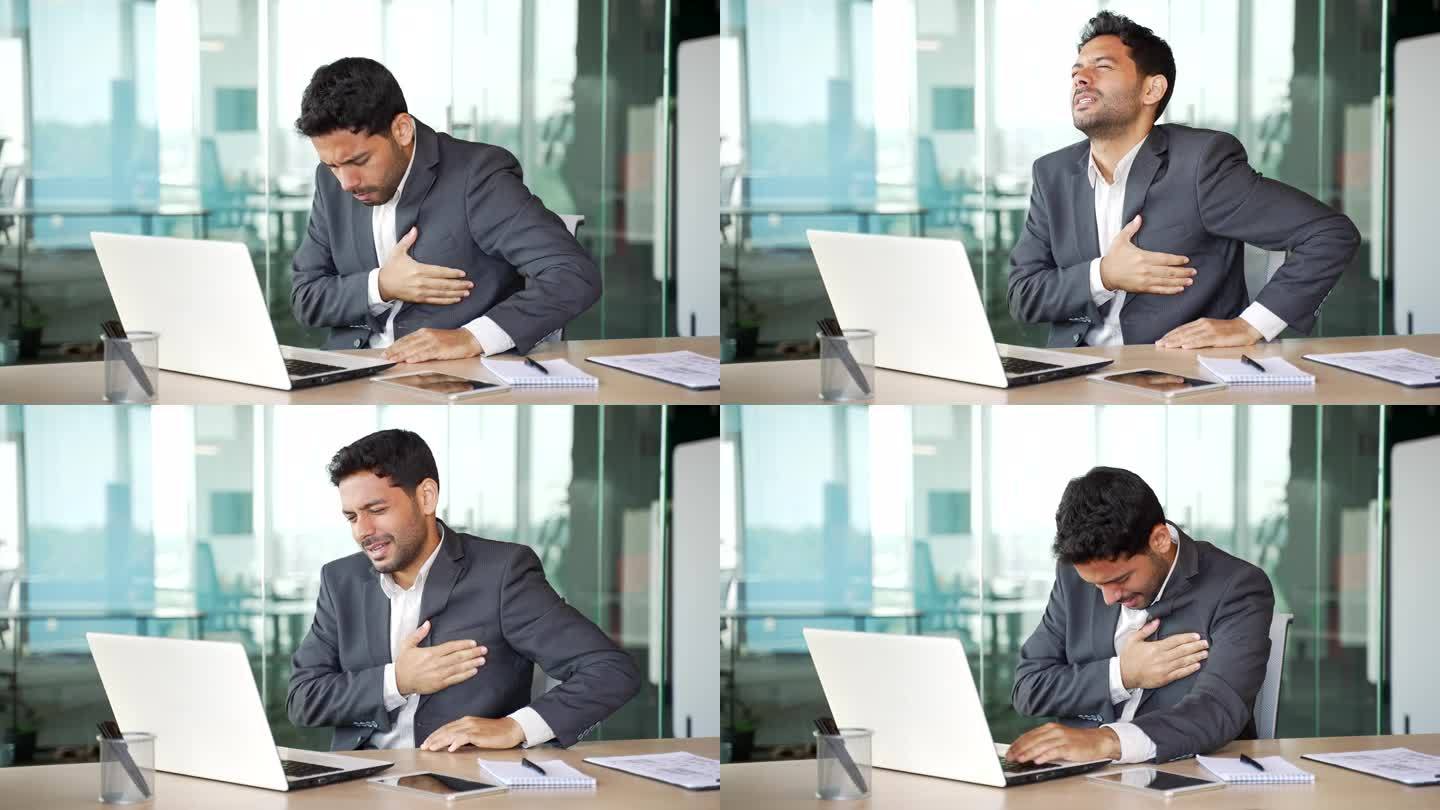 一个西装革履的年轻商人在办公室用笔记本电脑工作时突发心脏病