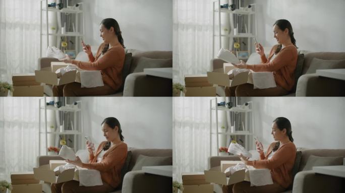 一名女子用智能手机打开网购后的包装盒