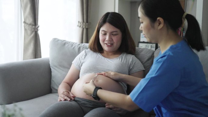 医生用听诊器检查孕妇腹部