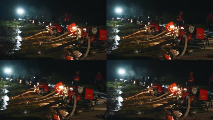 消防队员在夜间通过坚固的管道和强力的消防水管网络抽水