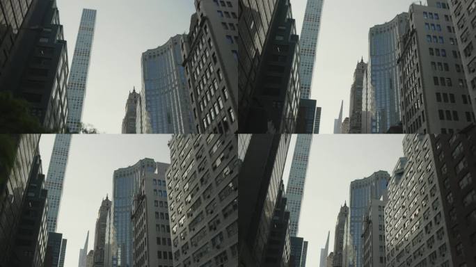 纽约市区观光。一名游客驾车穿过曼哈顿下城，仰望着巨大的办公楼、住宅楼和商业摩天大楼