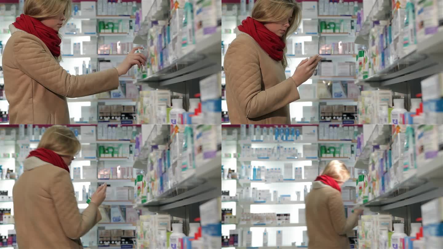 女顾客从药店货架上取药膏