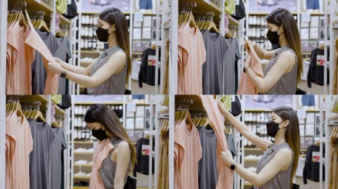 一位戴口罩的妇女在布店挑选衣服