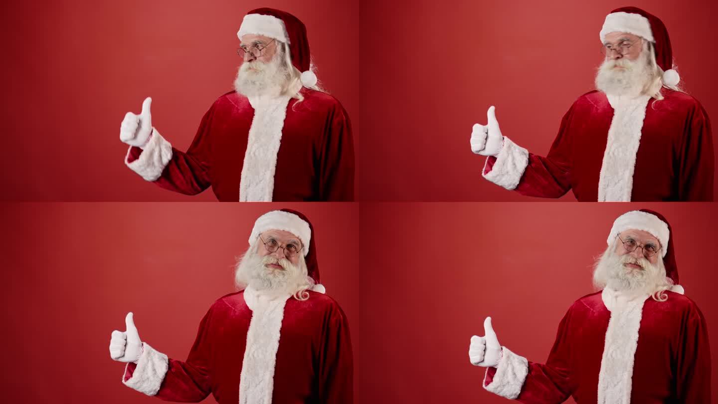 快乐的圣诞老人举起大拇指，红色背景
