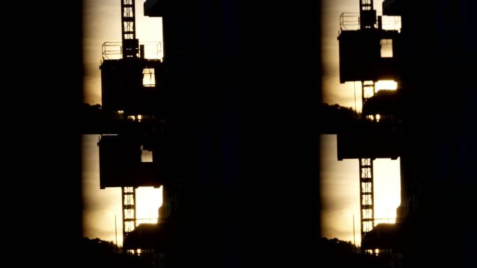 日落晚霞照在建筑工地升降机上升视频素材