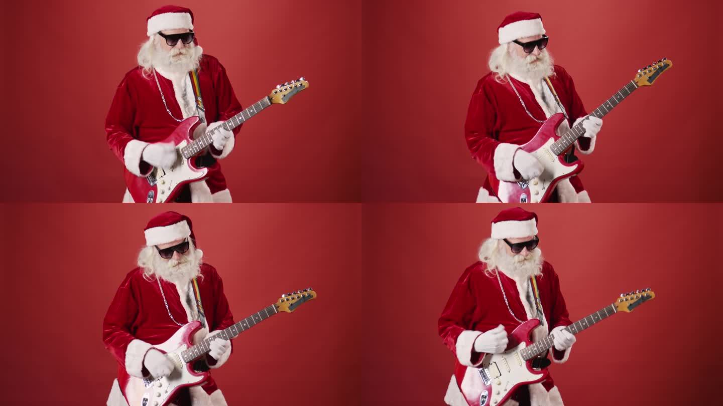 时髦的圣诞老人戴着墨镜弹电吉他