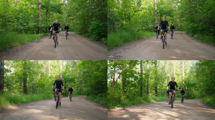 女孩朋友骑自行车，骑自行车在美丽的森林在夏天的周末，年轻的成年妇女