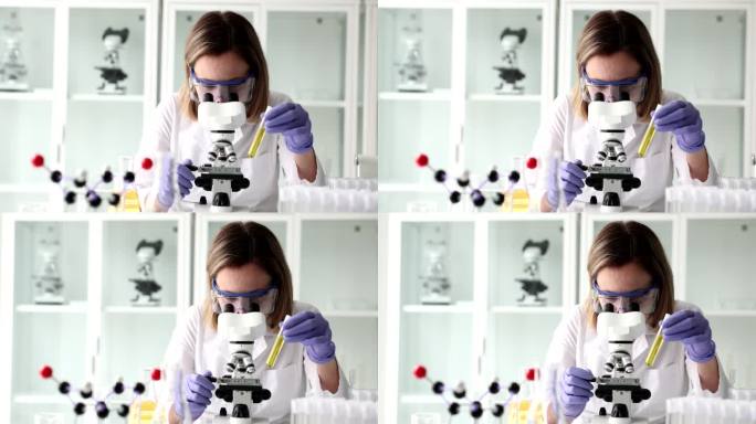 化学家用黄色液体握住试管看显微镜