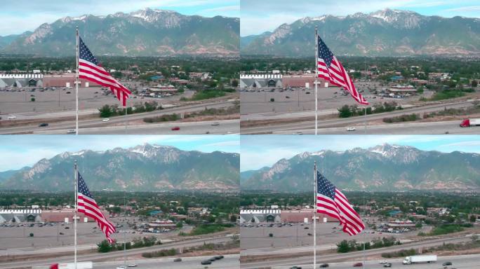 在日落前的一个夏夜，无人机在犹他州桑迪市拍摄了一面飘扬的美国国旗