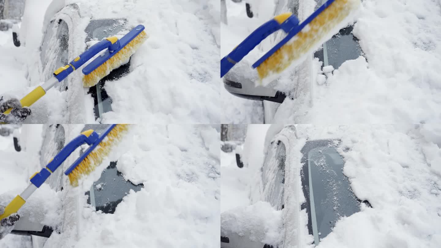 一个女人用雪刷清除汽车挡风玻璃上的雪的特写。冬季天气的概念，汽车保养，并为下雪的条件做好准备