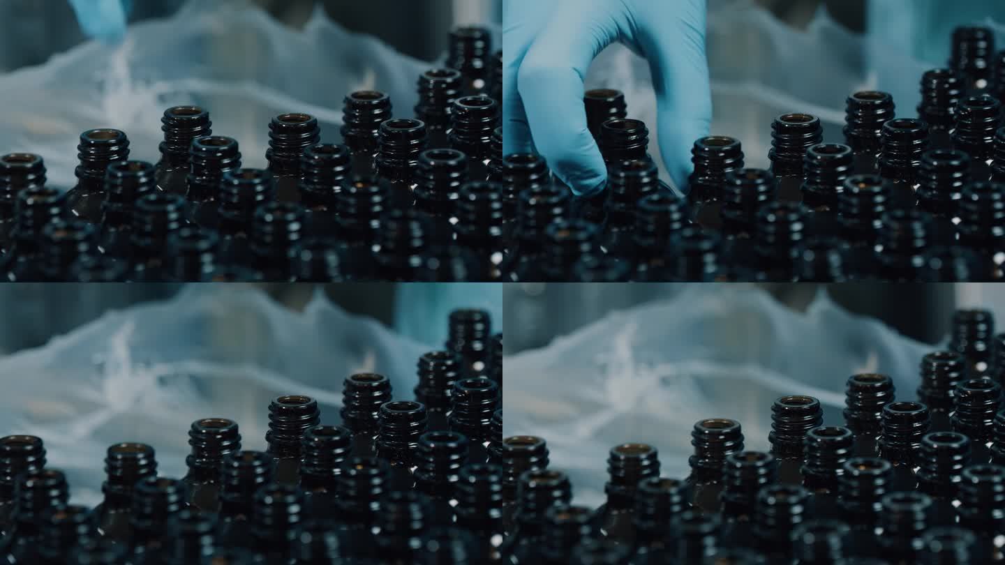 一只戴着橡胶手套的手拿着空玻璃瓶。现代工厂的包装工艺。空注射玻璃小瓶。制药生产。近距离镜头4K