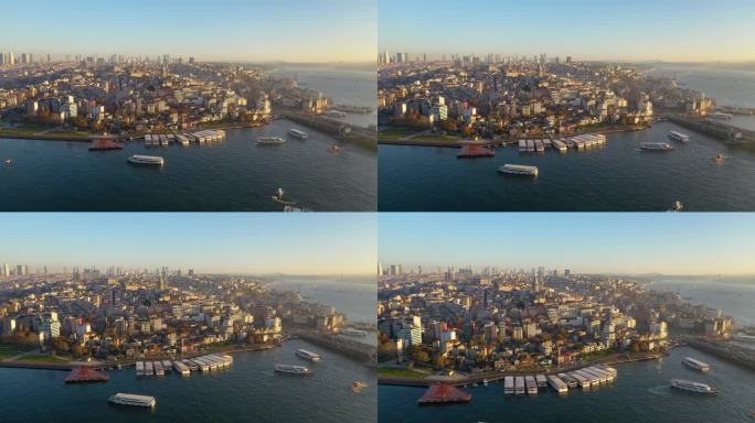 日落时分，无人机飞过海面，飞向加拉塔并拍照。海陆空交通鸟瞰图。伊斯坦布尔,土耳其。