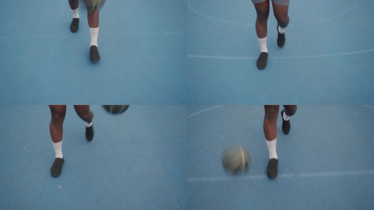 篮球运动员在球场上走着，弹着球