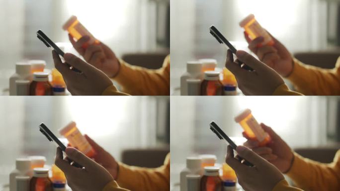 特写:一名女子一边看药盒上的标签，一边使用智能手机