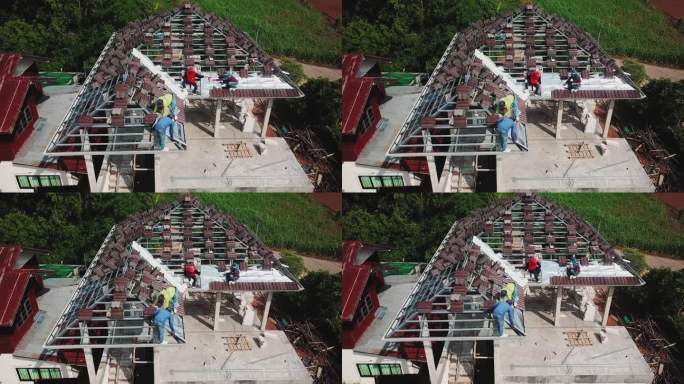 无人机拍摄的屋顶工人在屋顶上工作。