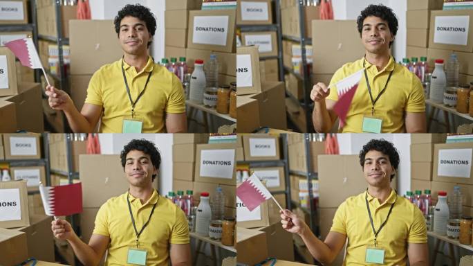 年轻的拉丁男子志愿者手持卡塔尔国旗微笑着在慈善中心