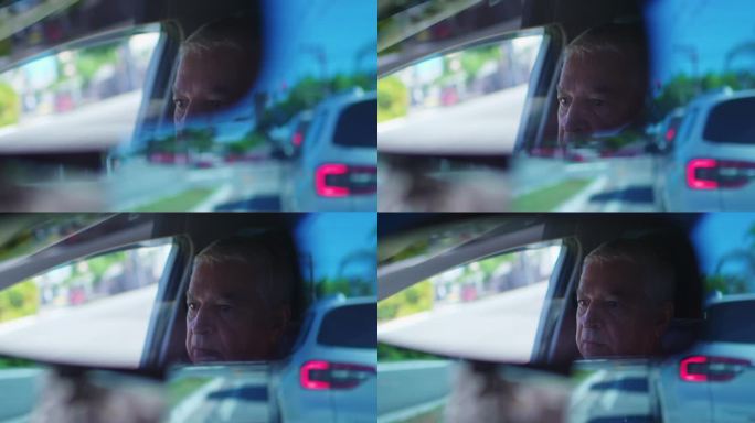 交通停滞的老人，后视镜拍摄的城市驾驶场景。老年人被困在交通堵塞中