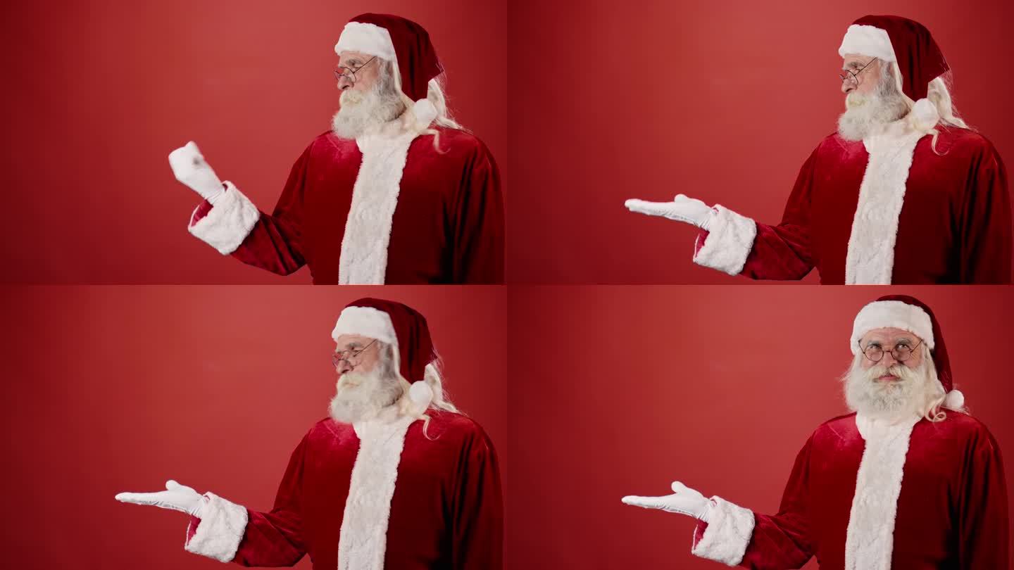 微笑的圣诞老人伸出手拿东西，红色背景