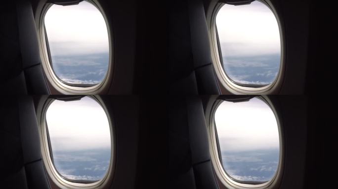 从云层上的飞机窗口看出去