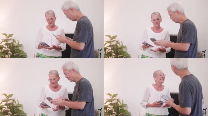 快乐的老年女性和男性使用智能手机和平板电脑