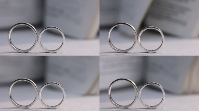 结婚婚礼戒指拍摄婚戒白色桌布书页翻动光影