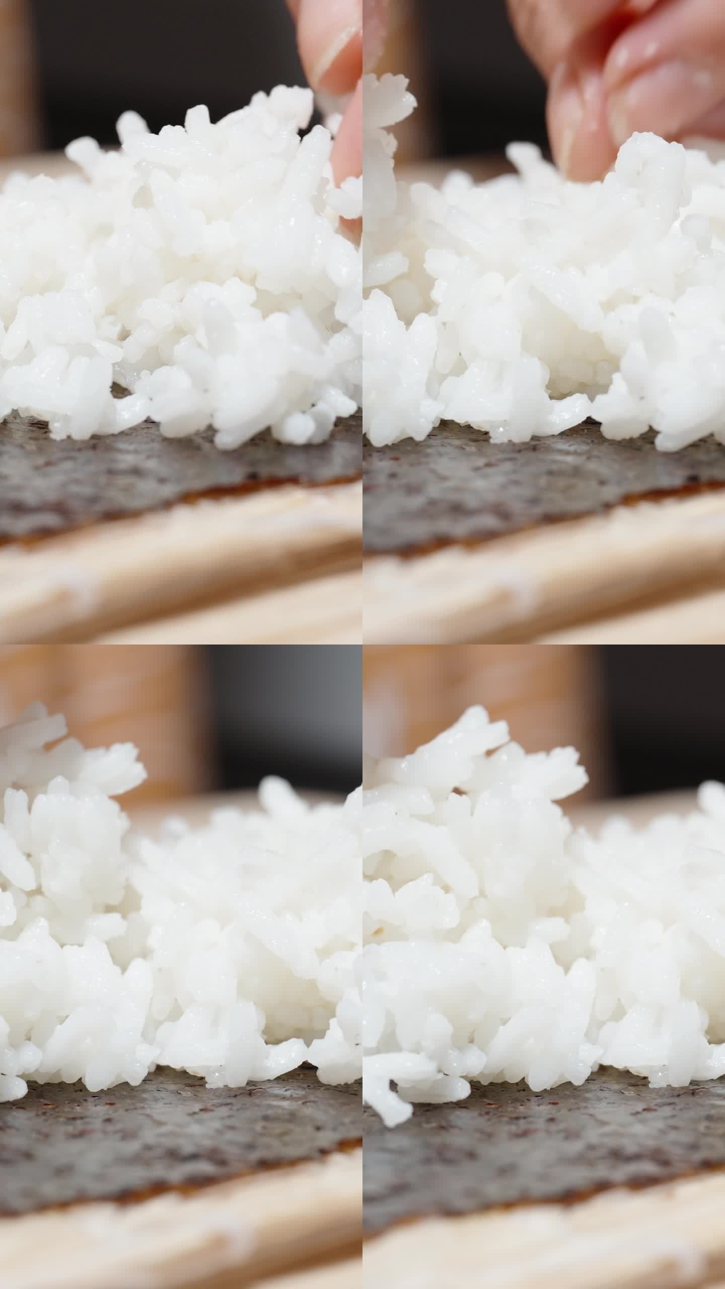垂直视频。女人把米饭放在海苔上，做成卷。特写镜头。