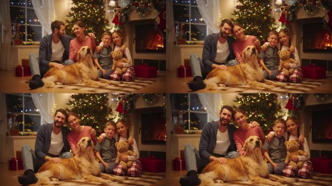 可爱的白人家庭微笑着看着镜头，互相拥抱。年轻的父亲和母亲与两个孩子和一只宠物狗合影。坐在有圣诞树的节
