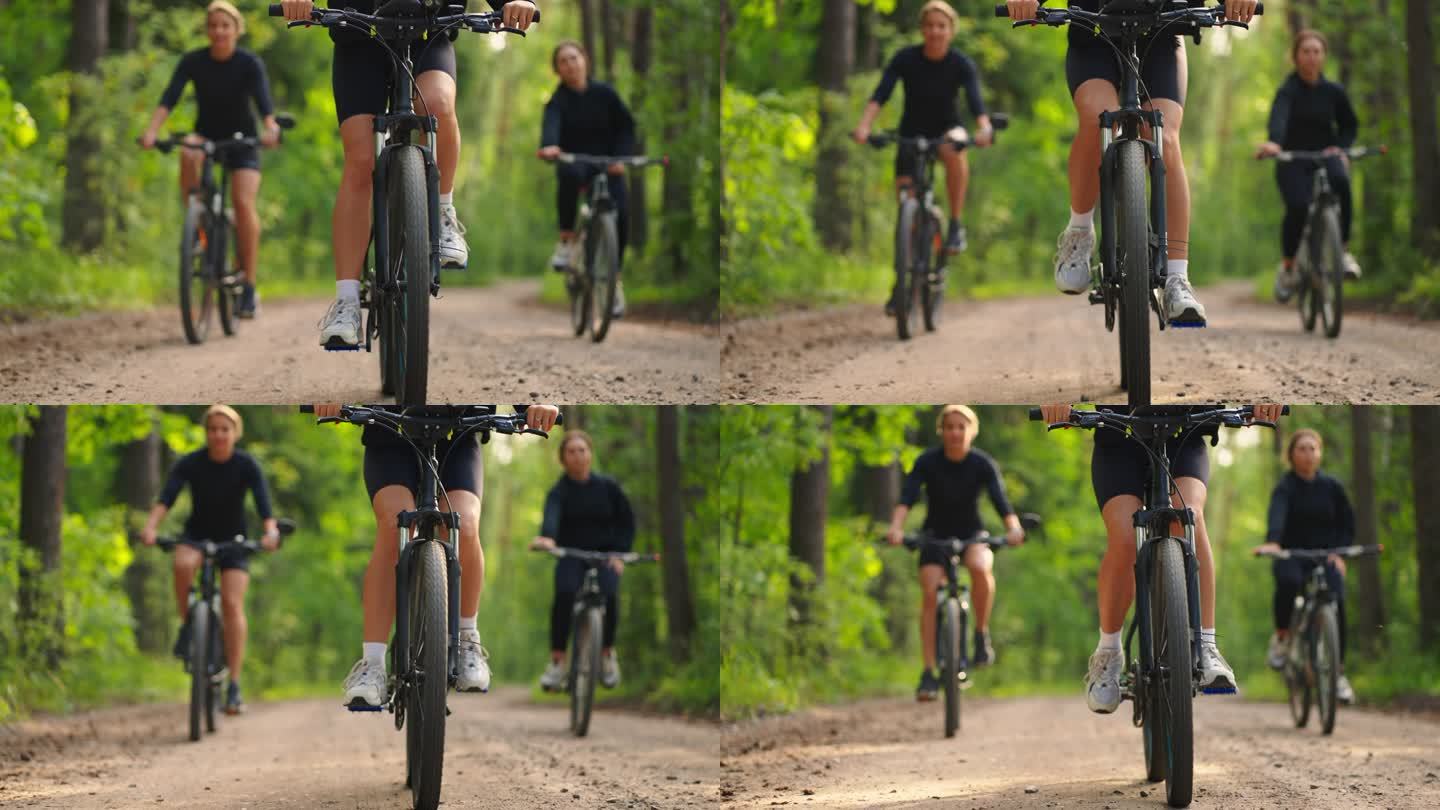 周末在大自然中积极休息，夏天在森林里骑自行车的妇女，车轮的细节视图