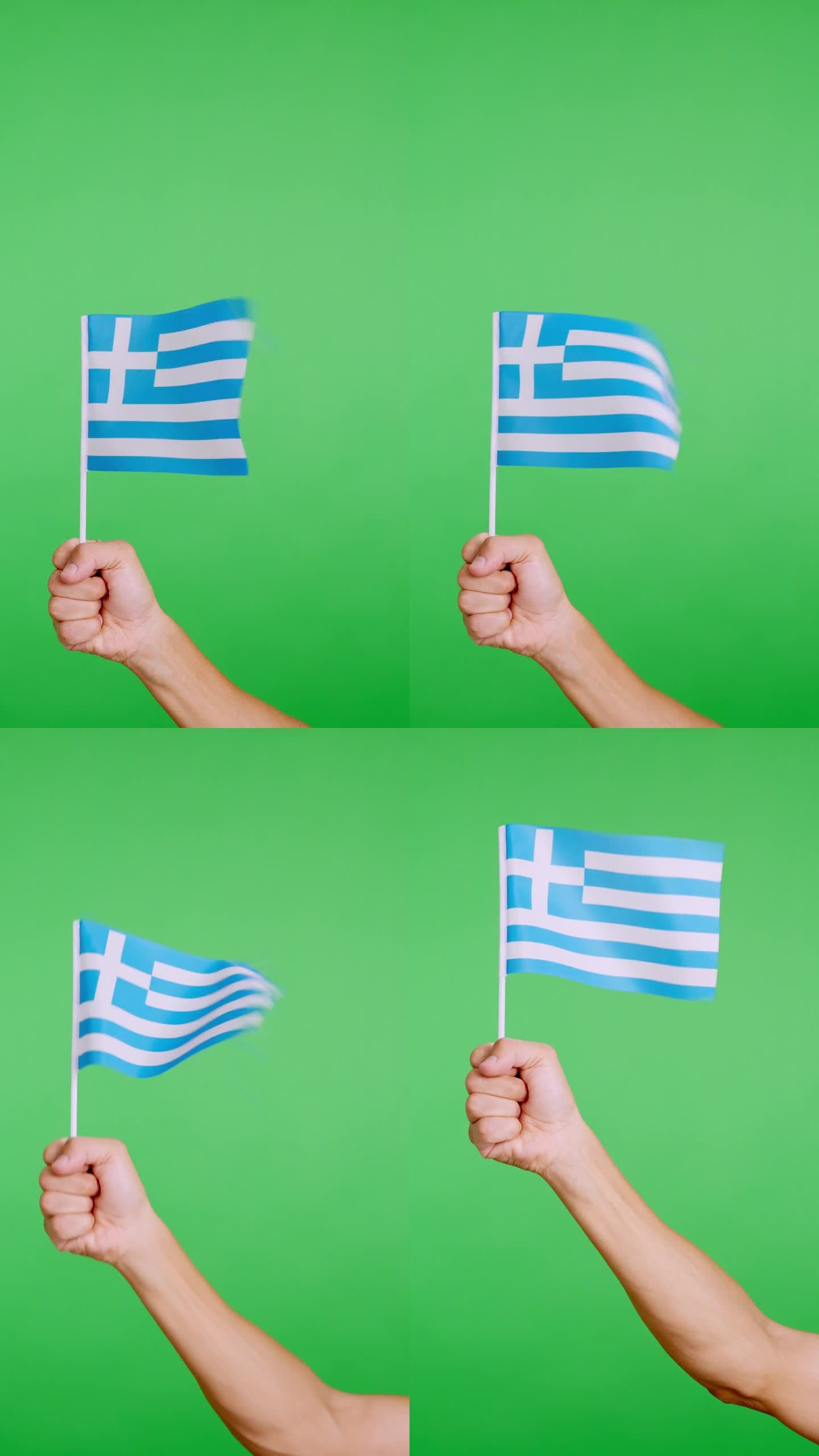 手举着希腊三角旗，在风中挥舞