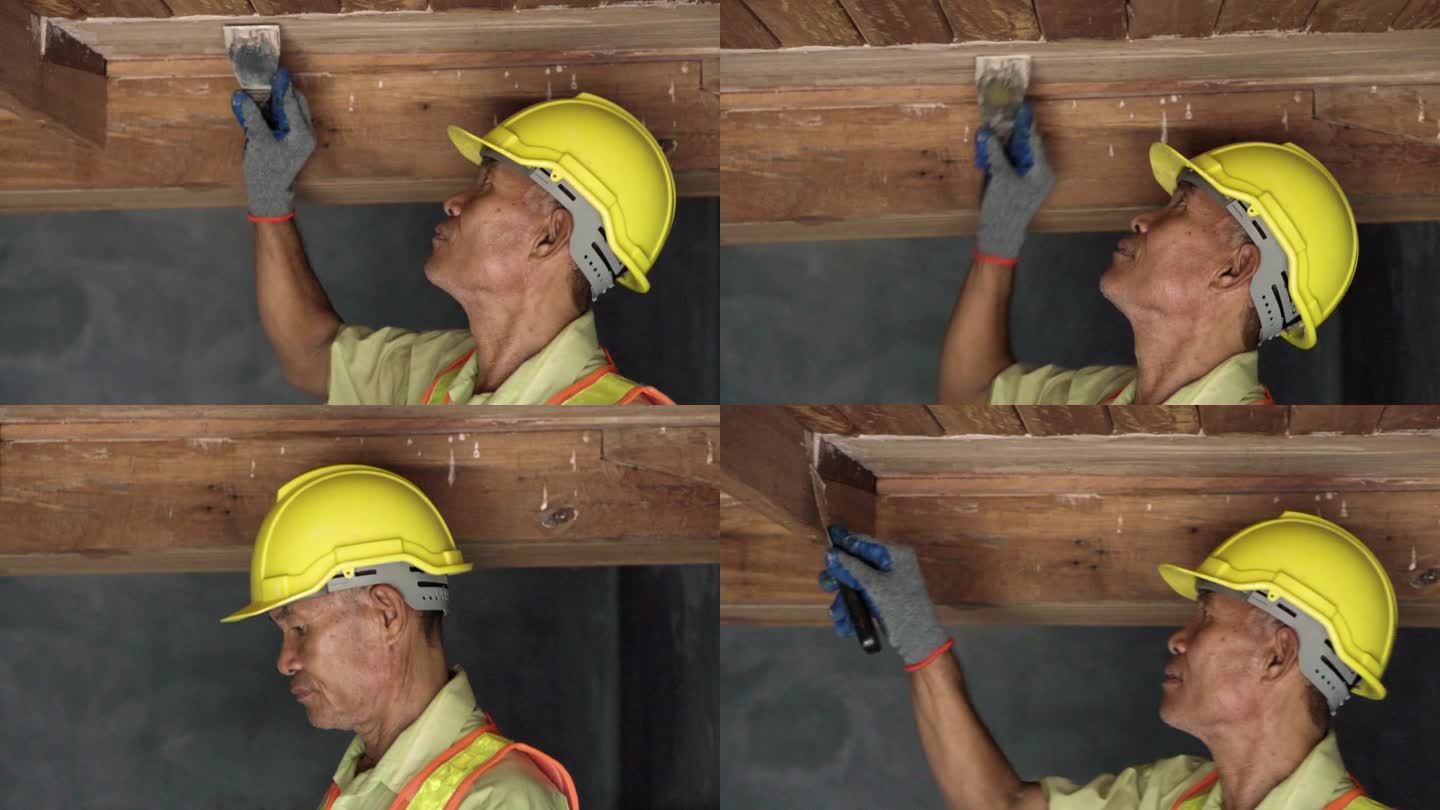 亚洲资深木匠在家里补天花板的缝隙。