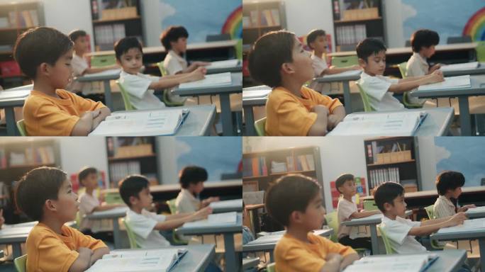 一大群快乐的小学生在课堂上专注地回答老师的问题