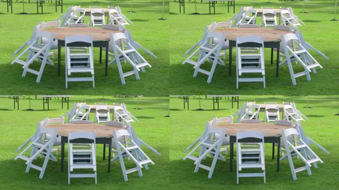 椅子围绕着花园草地上的圆桌，以4k慢动作60fps拍摄