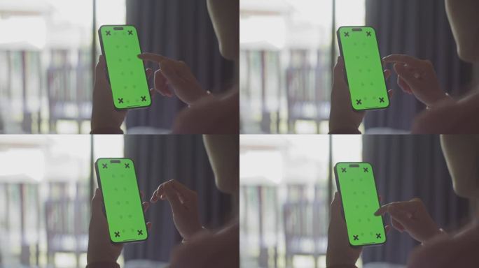 特写手女人使用绿色屏幕的智能手机