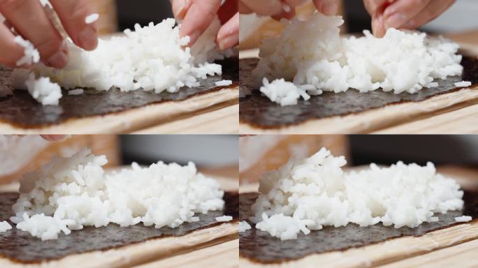 女人把米饭放在海苔上，做成卷。特写镜头。