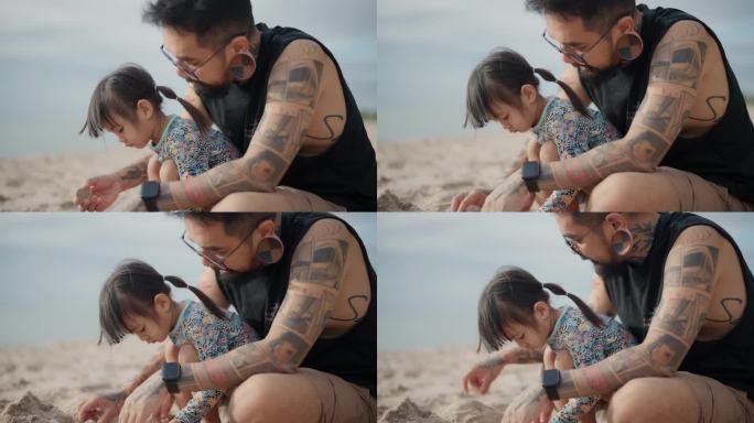 快乐的亚洲家庭在海滩度假，享受户外活动。可爱的小女孩坐在沙滩上和爸爸一起在沙滩上玩。