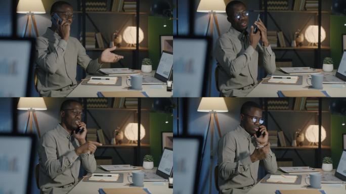 非裔美国人，晚上在黑暗的办公室里用手机打电话，做笔记