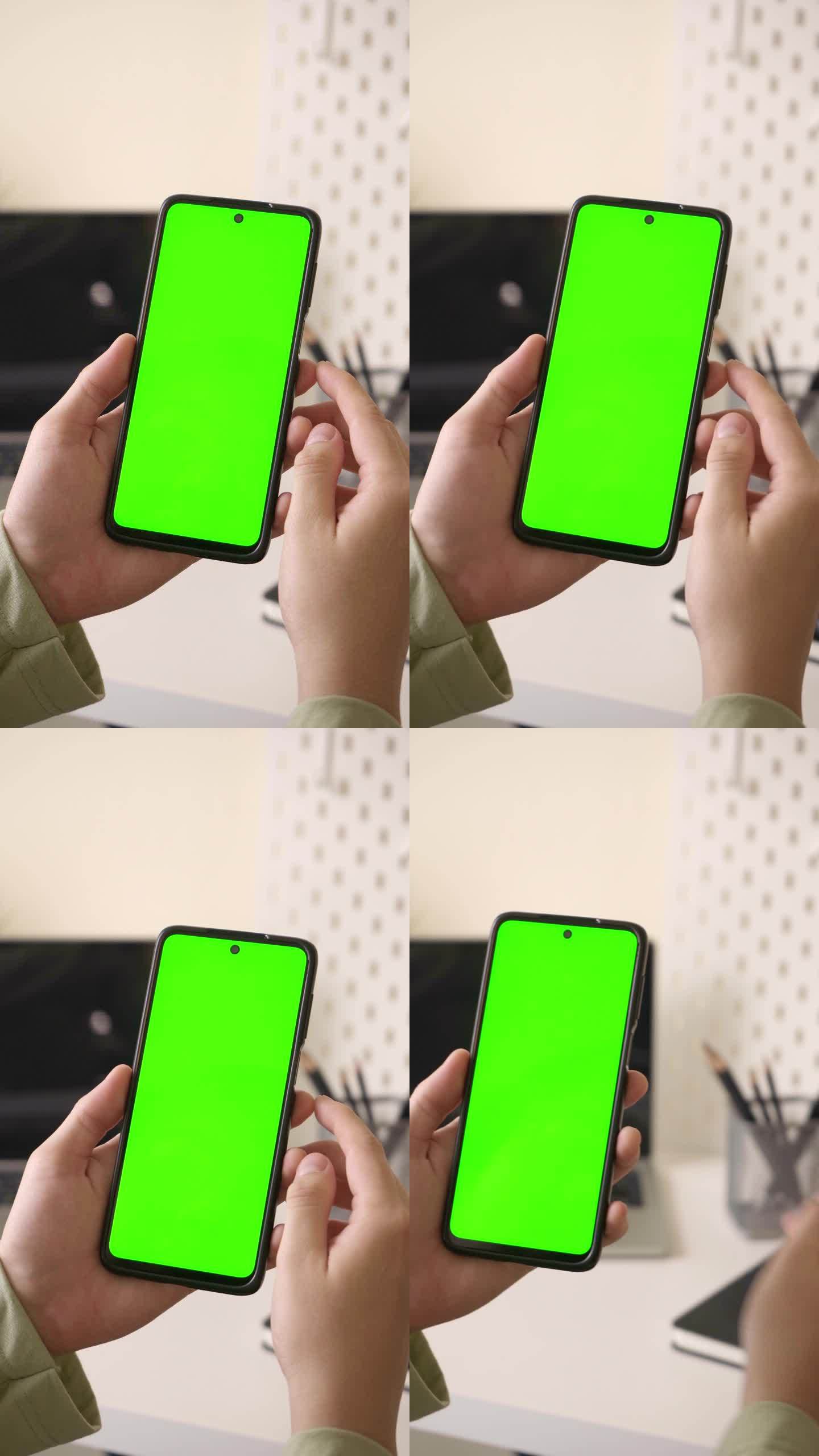 在办公室用绿屏手机设置色度键，在触摸屏上滚动应用程序，拿起车钥匙出门。室内场景。观点。垂直视频。