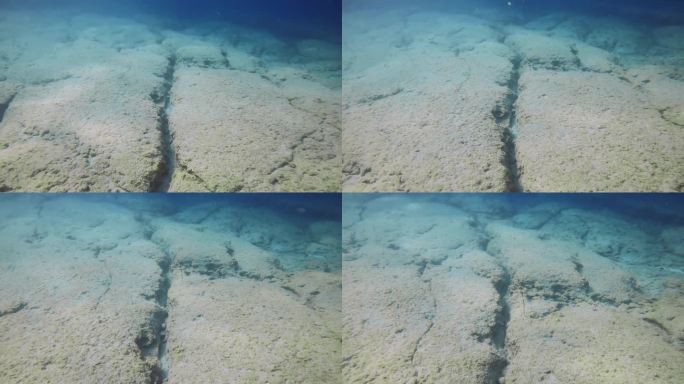 希腊地中海，布满裂缝的浮雕岩石海床
