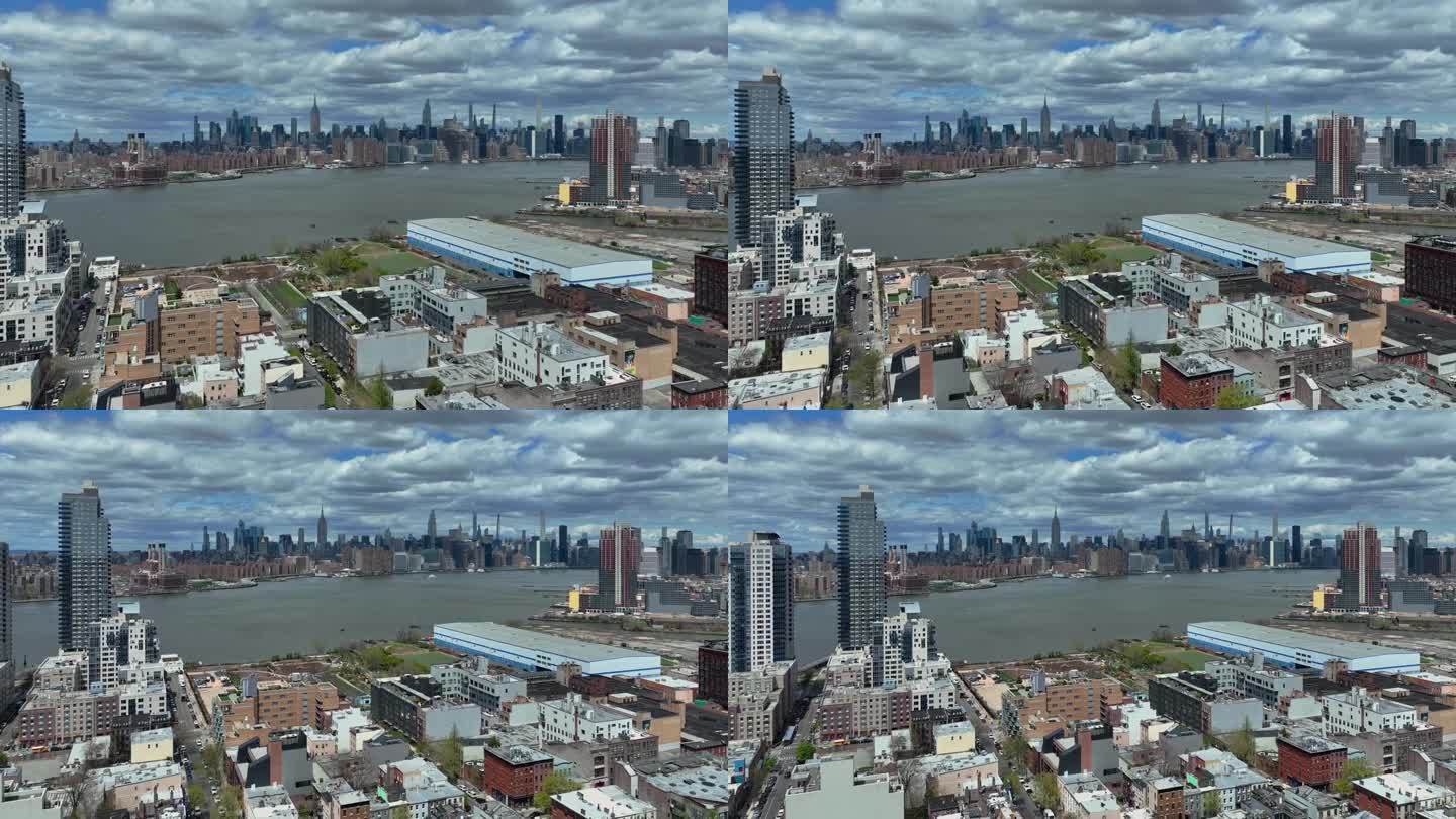 空中向后拍摄显示纽约天际线背后的东河在晴天和阴天-从布鲁克林区与贵族住宅区